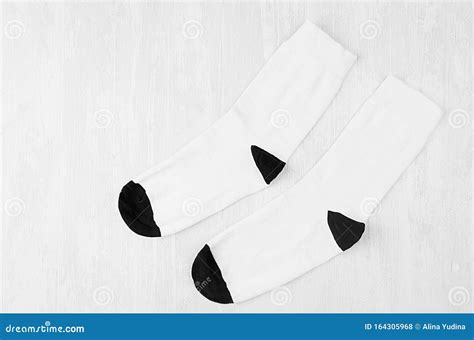 Pair Blank Black Medium Socks Flat Lay On White Wood Board Side View Mock Up For Design