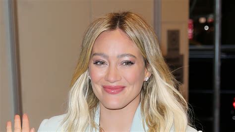 hilary duff covers her stomach with a baggy blazer and book in nyc as fans suspect she s