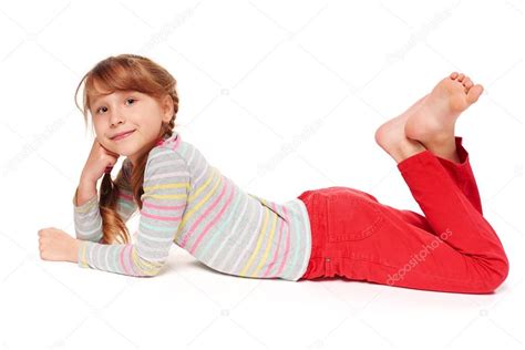 Side View Of Smiling Child Girl Lying On Stomach Stock Photo By ©pavel