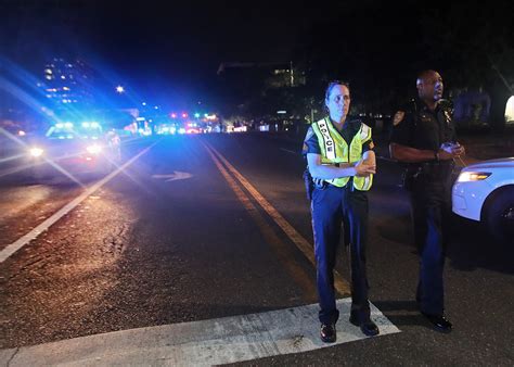 Police Review Board Member Ousted for 'Abolish Police' Sticker Sues