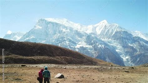 couple trekking to ice lake part of the annapurna circuit trek himalayas nepal they are