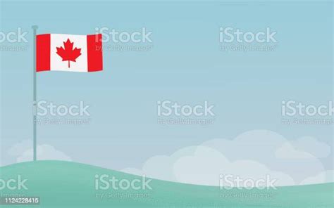 Canadian Flag Waving On A Pole Against Blue Sky Background With
