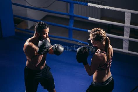 Sporty Muscular Young Man And Woman Boxing Together Isolated On Black