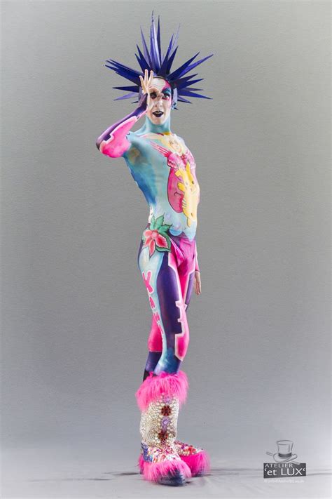 A Male Figure With Blue Hair And Pink Fur On It S Legs Standing In