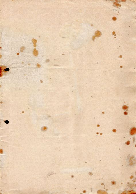 An Old Piece Of Paper With Rusted Edges And Black Dots On The Bottom Corner