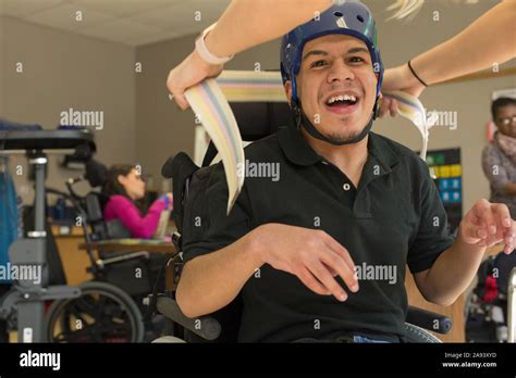 Boy With Spastic Quadriplegic Cerebral Palsy Using Using His Helmet And