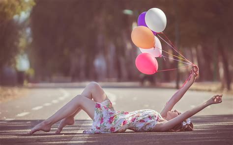 Girl With Balloons In Hand Lying Down Road Wallpaper HD Girls