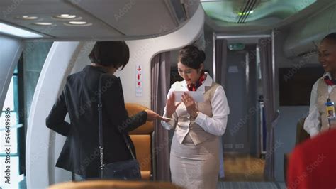 Passengers Boarding The Plane With Boarding Pass Checked By Flight