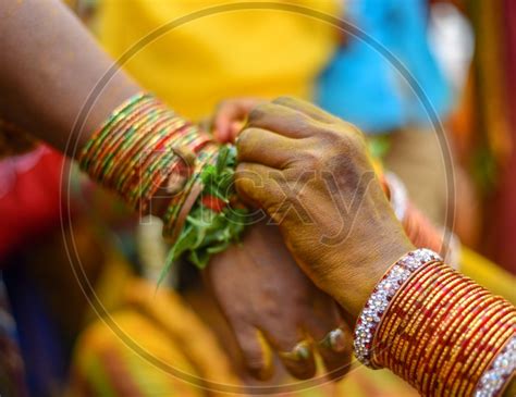 Image Of Kankanam Or Hand Bands Being Tie To Wrists During Bonalu