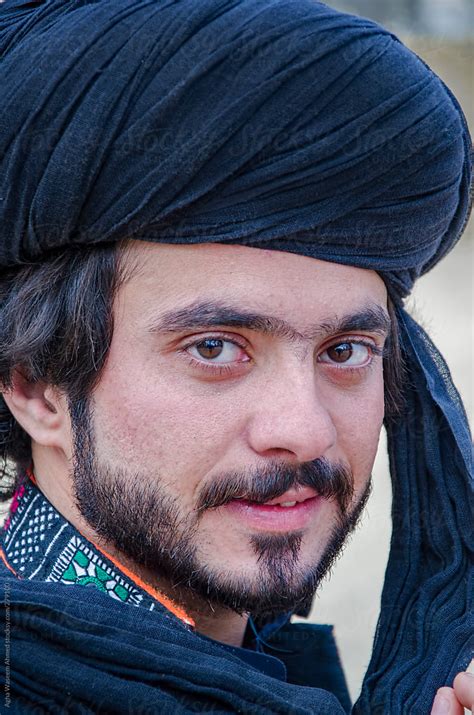 A Young Balochi Handsome Man Having Small Beard And A Black Turban By