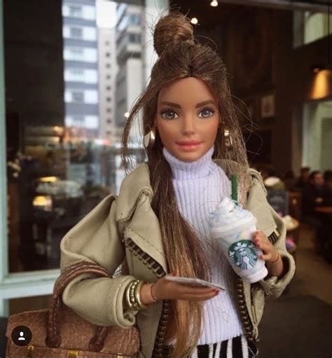 A Barbie Doll Holding A Starbucks Cup And Cell Phone