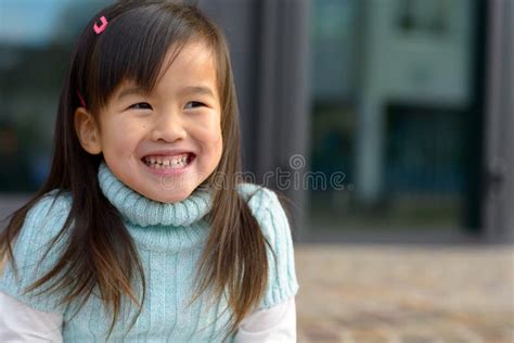 Friendly Little Asian Girl With A Playful Smile Stock Photo Image Of