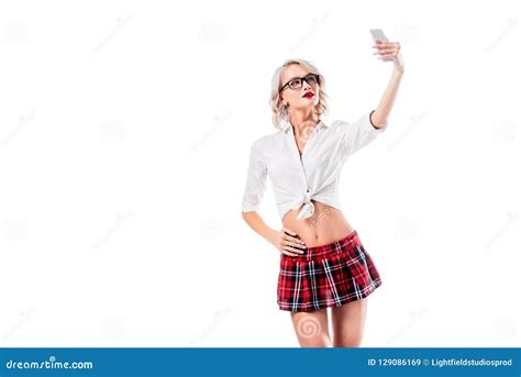 Portrait Of Seductive Blond Woman In Eyeglasses And Schoolgirl Clothing Taking Selfie On
