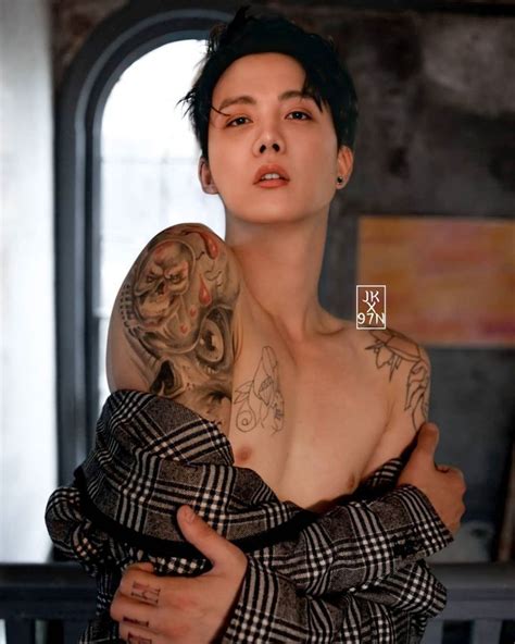 A Woman With Tattoos On Her Arm And Chest