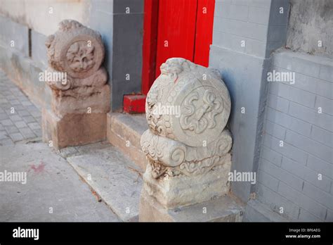 A Pair Of Stone Carved Mendun Guarding The Gate Of A Hutong Courtyard