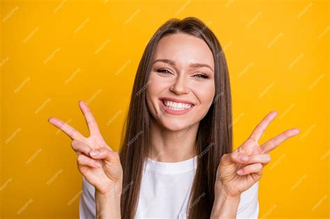 Premium Photo Photo Portrait Of Excited Smiling Girl Showing Two V Signs Isolated On Vivid