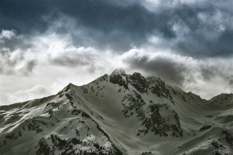 Photo Of Snow Capped Mountain Under Cloudy Sky · Free Stock Photo