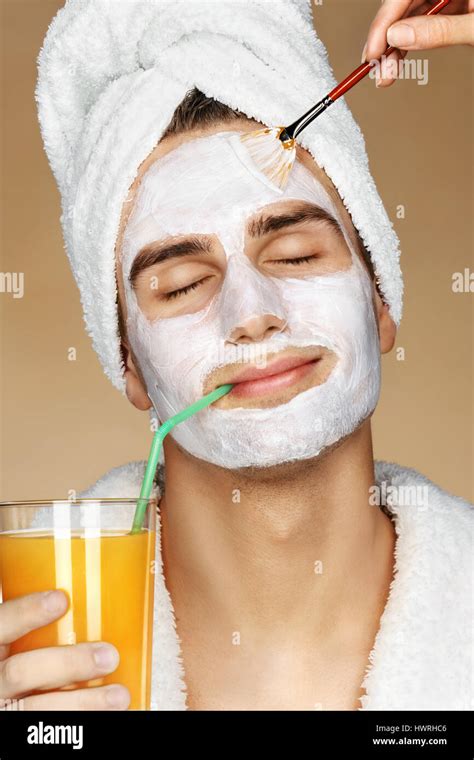 Handsome Man Getting A Facial Treatment Beautician Is Applying Facial