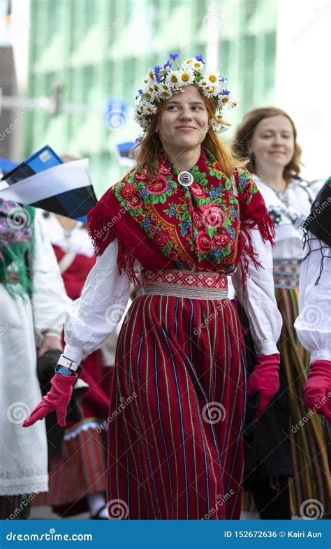 Estonian People In Traditional Clothing Walking The Streets Of Tallinn