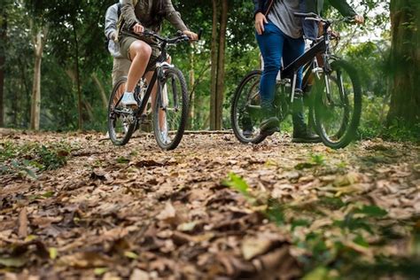 Premium Photo Group Of Friends Ride Mountain Bike In The Forest Together