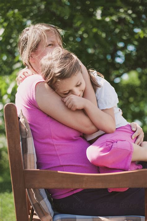 Mother And Daughter Hugging Each Other Girl Frowning Stock Photo My
