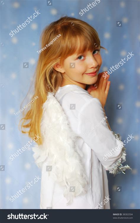 Angel Girl With Hands Folded To The Prayer On Blue Background Stock