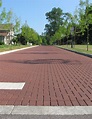 Permeable clay pavers cost less than asphalt - Pine Hall Brick, Inc.