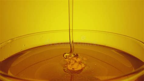 Honey Dripping Pouring From Spoon In Glass Thick Honey Molasses Dripping Into Full Glass