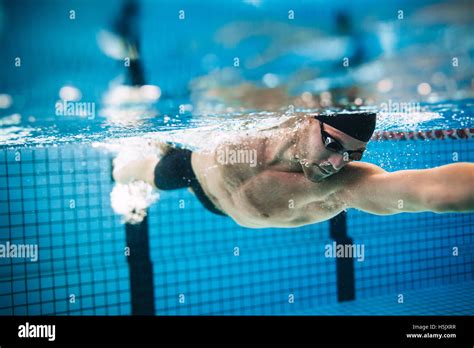 Underwater Shot Of Professional Male Athlete Swimming In Pool Man