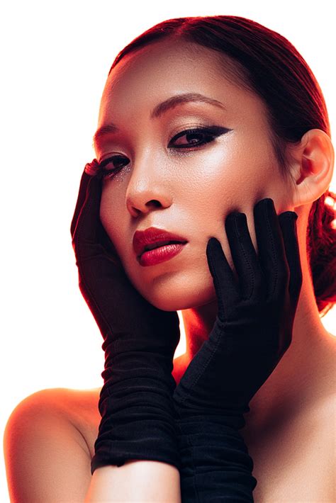 유토이미지 brunette asian girl in black gloves with makeup in red light isolated on white