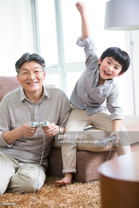 Cheerful Grandfather And Grandson Playing Video Game Stock Foto Getty