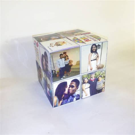 A Photo Cube With Four Pictures Of People On It And One Is In The Middle