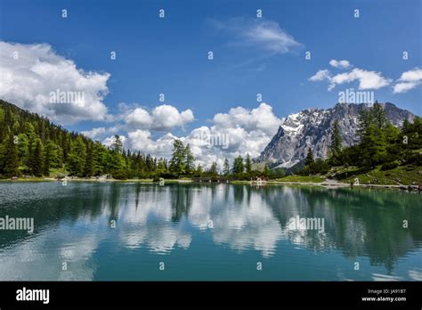 Zugspitze Mountain Range Reflected In The Clear Turquoise Water Of Lake