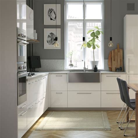 Kitchen storage organizers turn chaos into things of beauty and efficiency. A modern, bright, and airy kitchen with wooden detail - IKEA