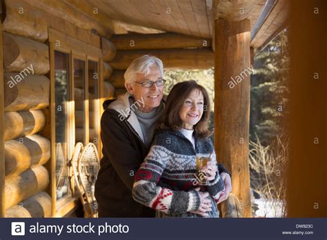 Thoughtful Couple Standing On Cabin Porch Stock Photo Alamy
