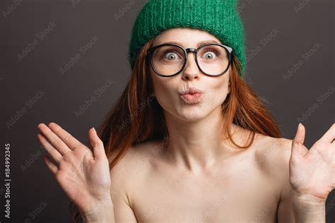 Naked Ginger Woman Wearing Circle Glasses And Green Hat Pouting Her