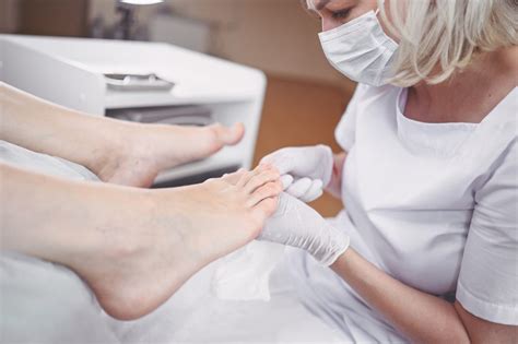 Pedicurist Doing Professional Medical Pedicure Procedure In Beauty