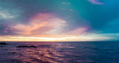 Colorful Sunset Over Water With Seagulls On Rocks Stock Photo Image