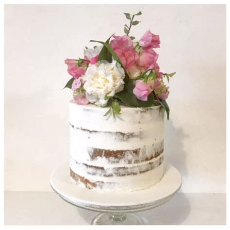 semi naked cake with fresh flowers three sweeties