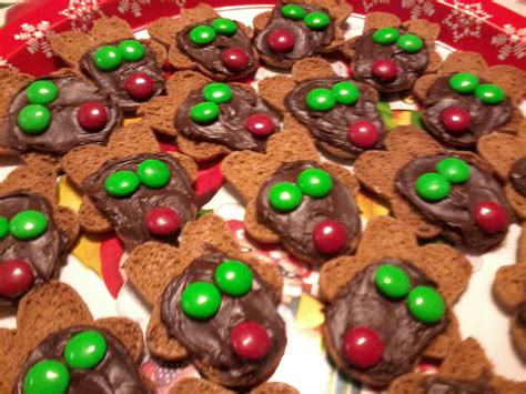 With the black icing, pipe an outline around the head of each cookie, around the arms and across the chest with a bowed line. reindeer cookies made from upside down gingerbread men ...