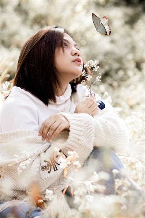 Woman In White Sweater Holding White Flowers · Free Stock Photo