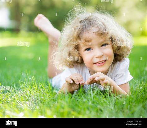 Happy Child Playing On Green Grass In Spring Park Stock Photo Alamy