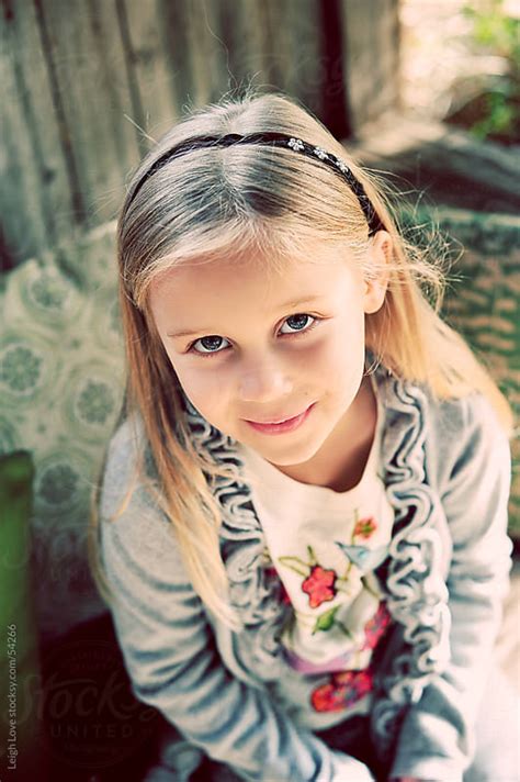 Young Blonde Hair Blue Eyed Girl Looking Up At The Camera By Leigh