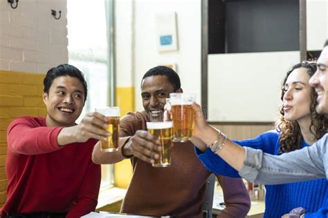 multiethnic friends drinking beer at brewery bar restaurant on weekend friendship concept with