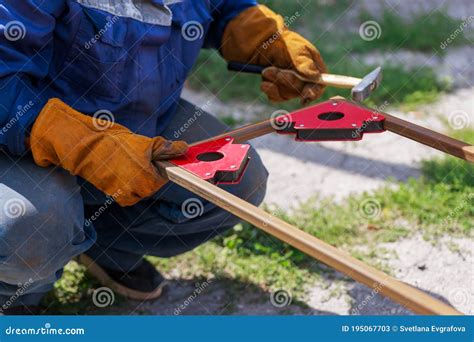 Working Auxiliary Tools In The Hands Of A Worker Welder Using A