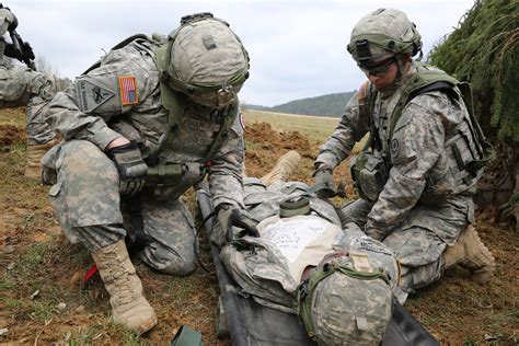 Us Soldiers Strap A Simulated Wounded Soldier To A Litter During