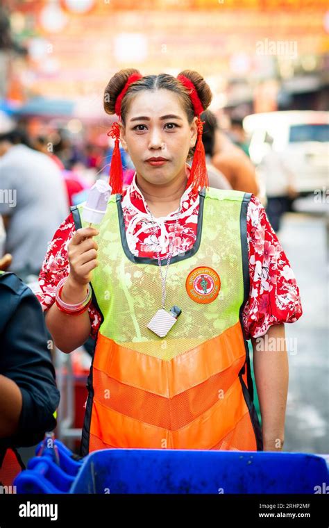 A Thai Road Sweeper Enjoys An Ice Cream On Her Break On Yaowarat Rd