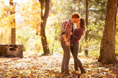 Young couple kissing in autumn forest - Stock Photo - Dissolve