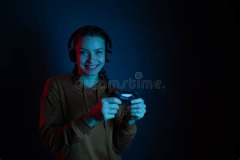 The Gamer Happy Smiling Woman With Headphones And Joystick Playing