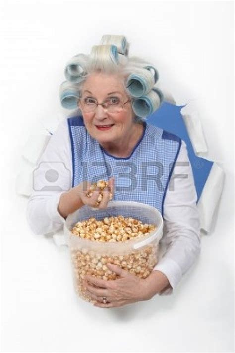 Senior Woman With Curlers In Her Hair Eating Popcorn Hair Curlers